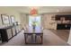 Bright dining room with an elegant chandelier and access to the kitchen at 10123 Carp Hollow Rd, Sun City Center, FL 33573