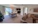 Open-concept dining area with modern table, chairs, and backyard views at 10123 Carp Hollow Rd, Sun City Center, FL 33573