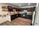 Well-lit kitchen featuring dark cabinets and modern appliances at 10123 Carp Hollow Rd, Sun City Center, FL 33573