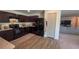 Functional kitchen featuring dark cabinets and a view leading into a cozy living area at 10123 Carp Hollow Rd, Sun City Center, FL 33573