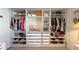 A well-organized walk-in closet with shelves, drawers, and hanging rods at 10123 Carp Hollow Rd, Sun City Center, FL 33573