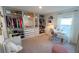 Large walk-in closet features custom shelving, vanity, and ample storage space at 10123 Carp Hollow Rd, Sun City Center, FL 33573