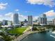 A sunny aerial view of downtown buildings, a waterfront stadium, and blue sky in this scenic city at 10340 2Nd N Way, St Petersburg, FL 33716