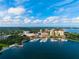 This aerial displays a marina filled with boats, with hotels and waterfront views under a partly cloudy sky at 10340 2Nd N Way, St Petersburg, FL 33716