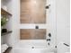 A stylish bathroom featuring decorative wooden tile work, a glass shower, and floating shelves at 10340 2Nd N Way, St Petersburg, FL 33716