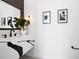 Modern bathroom with patterned marble countertop, black faucet, and modern art on the bright wall at 10340 2Nd N Way, St Petersburg, FL 33716