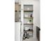 Bright bathroom showing a glass shower with rain shower head and decorative built in shelves for extra storage at 10340 2Nd N Way, St Petersburg, FL 33716
