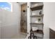 Modern bathroom featuring a glass enclosed shower, and built in shelves with towels and decorations at 10340 2Nd N Way, St Petersburg, FL 33716