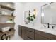 Elegant bathroom with double vanity, modern fixtures, and a built-in shelf unit, showcasing a luxurious design at 10340 2Nd N Way, St Petersburg, FL 33716