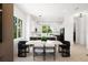Bright dining area showcasing modern furnishings and open access to a modern kitchen with sleek white cabinetry at 10340 2Nd N Way, St Petersburg, FL 33716