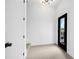 Bright entryway featuring a dark door, wooden floors, and a view of the outdoor neighborhood at 10340 2Nd N Way, St Petersburg, FL 33716