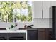 Contemporary kitchen featuring a large window, sleek countertops, and a stylish backsplash at 10340 2Nd N Way, St Petersburg, FL 33716
