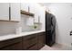 Modern laundry room with white cabinets, countertop, under cabinet lights, and new washer and dryer at 10340 2Nd N Way, St Petersburg, FL 33716