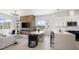 Bright living area with open concept, designer finishes, wood accent wall, and modern kitchen with island at 10340 2Nd N Way, St Petersburg, FL 33716