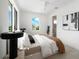 Modern main bedroom featuring bright light, neutral decor, and a ceiling fan at 10340 2Nd N Way, St Petersburg, FL 33716