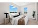 Bright main bedroom with modern décor, large windows, and sleek bedside lighting at 10340 2Nd N Way, St Petersburg, FL 33716
