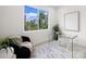 Bright office space with a glass desk, cozy chair, and large window with green views at 10340 2Nd N Way, St Petersburg, FL 33716
