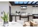 Rooftop outdoor kitchen with stainless steel grill, sink, and a cozy seating area for entertaining guests at 10340 2Nd N Way, St Petersburg, FL 33716
