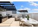 Beautiful rooftop terrace featuring an outdoor kitchen, comfortable seating, dining area, and a shade umbrella at 10340 2Nd N Way, St Petersburg, FL 33716
