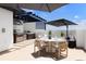 Rooftop terrace with outdoor kitchen, dining area, lounge seating, and a large shade umbrella at 10340 2Nd N Way, St Petersburg, FL 33716