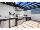 Rooftop outdoor kitchen with stainless steel appliances, grill, and a sleek design under a modern pergola at 10340 2Nd N Way, St Petersburg, FL 33716
