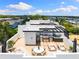 Stylish rooftop deck featuring an outdoor kitchen, jacuzzi, dining area, and lounge seating with city views at 10340 2Nd N Way, St Petersburg, FL 33716
