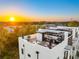 A luxury rooftop deck with sunset views features a well-equipped outdoor kitchen and dining area with lounge chairs at 10340 2Nd N Way, St Petersburg, FL 33716