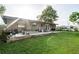 Backyard features expansive lawn, concrete patio, and mature trees at 10818 Land O Lakes Blvd, Land O Lakes, FL 34638
