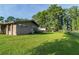 Expansive backyard with lush lawn, mature trees, and partial fencing at 10818 Land O Lakes Blvd, Land O Lakes, FL 34638
