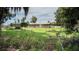 Residential home with storage sheds and carports surrounded by a chain link fence at 10818 Land O Lakes Blvd, Land O Lakes, FL 34638