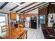 Kitchen and living room area with beamed ceilings, tile floor and breakfast table at 10818 Land O Lakes Blvd, Land O Lakes, FL 34638