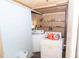 Functional laundry room with appliances, shelving, and ample space for sorting and storage at 10818 Land O Lakes Blvd, Land O Lakes, FL 34638