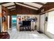 Bright open-concept living space with beamed ceilings and neutral tile floors at 10818 Land O Lakes Blvd, Land O Lakes, FL 34638