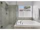 Bright bathroom showcasing a luxurious soaking tub and glass enclosed shower at 11324 Cypress Reserve Dr, Tampa, FL 33626