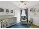 Cozy Bedroom with a crib, rocking chair, and moon-themed decor creating a serene atmosphere at 11324 Cypress Reserve Dr, Tampa, FL 33626