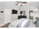 Bedroom features hardwood floors, dresser with TV, ensuite bathroom access, and plenty of natural light at 11324 Cypress Reserve Dr, Tampa, FL 33626