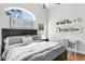 Bedroom with a queen-size bed, a large arched window, and a white desk at 11324 Cypress Reserve Dr, Tampa, FL 33626