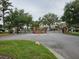 Gated entrance to the Sheffield community with lush landscaping and brick pillars at 11324 Cypress Reserve Dr, Tampa, FL 33626