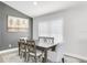 Chic dining room with a dark wood table, chairs, and large bright window at 11324 Cypress Reserve Dr, Tampa, FL 33626