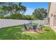 Backyard with a charming fire pit and Adirondack chairs, a great place for gatherings at 11324 Cypress Reserve Dr, Tampa, FL 33626