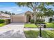 Charming single Gathering home features a well-manicured lawn, lovely landscaping, and two car garage at 11324 Cypress Reserve Dr, Tampa, FL 33626