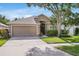 Charming single Gathering home features a well-manicured lawn, lovely landscaping, and two car garage at 11324 Cypress Reserve Dr, Tampa, FL 33626