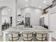 Bright kitchen island with marble countertops and seating for three at 11324 Cypress Reserve Dr, Tampa, FL 33626
