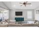 Cozy living room with a neutral-toned sectional sofa and a modern ceiling fan at 11324 Cypress Reserve Dr, Tampa, FL 33626