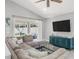 Spacious living room boasts a large sectional sofa, flat screen TV, and sliding glass doors to the porch at 11324 Cypress Reserve Dr, Tampa, FL 33626