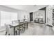 Open concept living and dining areas featuring hardwood floors, contemporary furniture and modern decor at 11324 Cypress Reserve Dr, Tampa, FL 33626