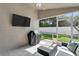 Relaxing screened-in patio with ceiling fan and outdoor grill at 11324 Cypress Reserve Dr, Tampa, FL 33626