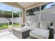 Relaxing screened-in porch with a comfortable couch, tile floors, and views of the backyard at 11324 Cypress Reserve Dr, Tampa, FL 33626