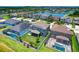An aerial view showcasing the home's backyard, fencing, and serene lake view in a residential neighborhood at 11612 Sunburst Marble Rd, Riverview, FL 33579