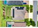 Aerial view of a house with solar panels, landscaped backyard, screened lanai, and proximity to other homes at 11612 Sunburst Marble Rd, Riverview, FL 33579